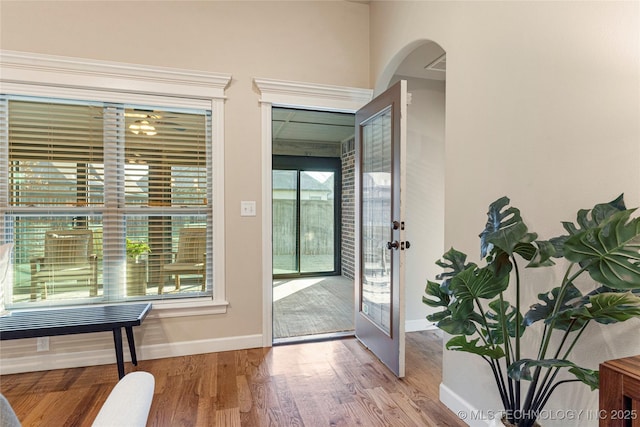 doorway to outside with a healthy amount of sunlight, light wood-type flooring, and french doors