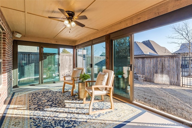 sunroom with ceiling fan and wood ceiling