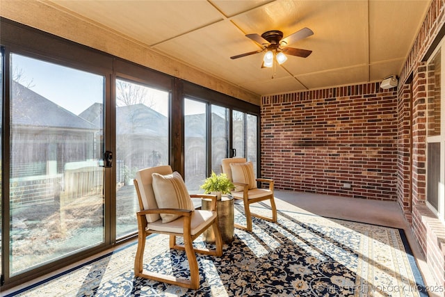 sunroom featuring ceiling fan and a mountain view