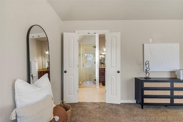 interior space featuring ensuite bath and carpet flooring