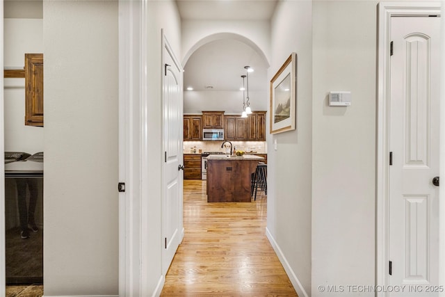 corridor featuring light hardwood / wood-style floors and washer and clothes dryer