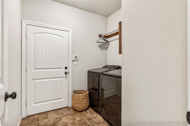 laundry room featuring washing machine and clothes dryer