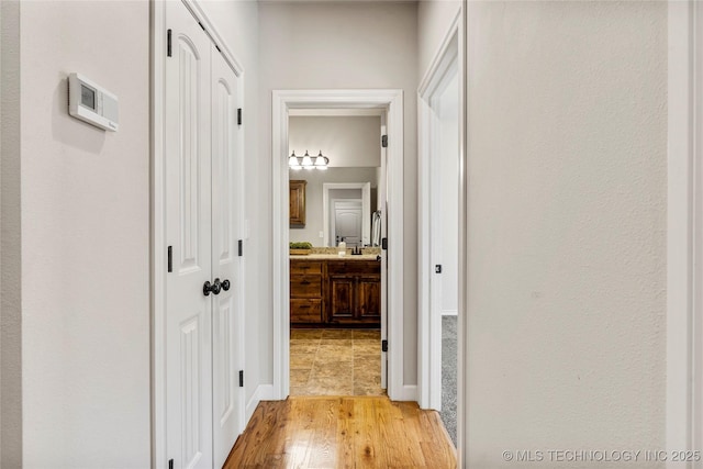 corridor with light wood-type flooring