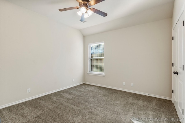 carpeted empty room with vaulted ceiling and ceiling fan