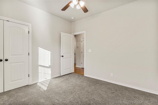 unfurnished bedroom with ceiling fan, a closet, and carpet