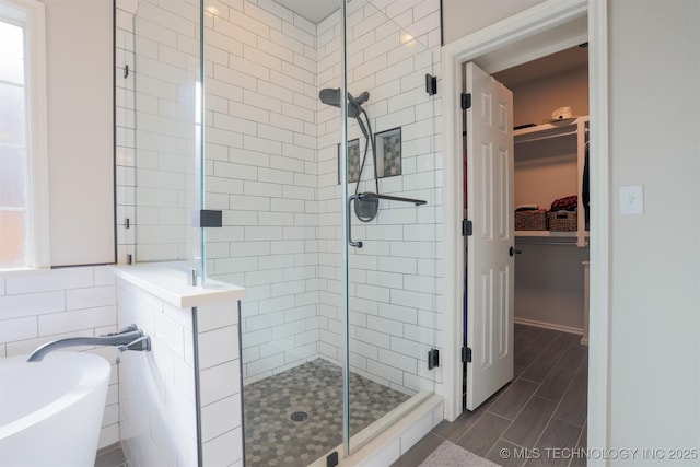 bathroom featuring shower with separate bathtub