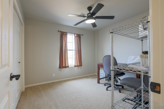 carpeted office space featuring ceiling fan