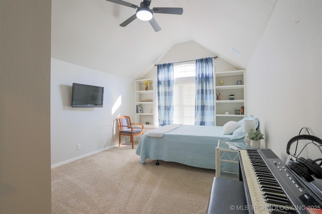 carpeted bedroom with ceiling fan and vaulted ceiling