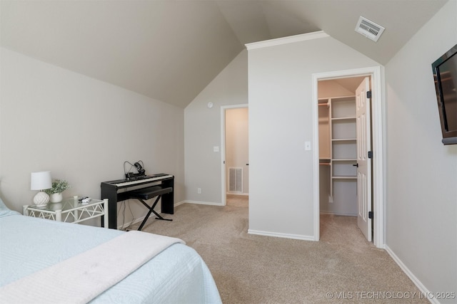 carpeted bedroom featuring lofted ceiling, a closet, and a spacious closet