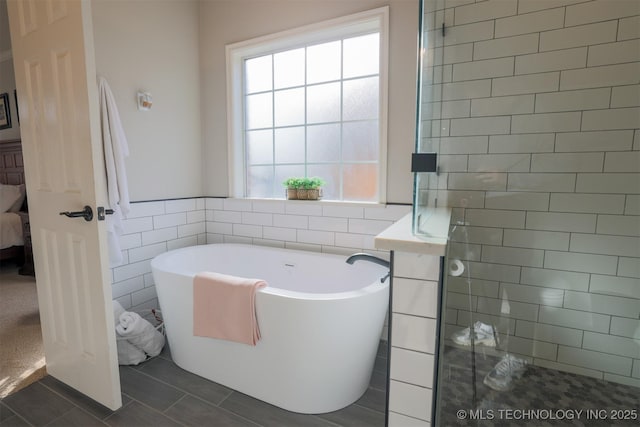 bathroom featuring tile walls, tile patterned floors, and independent shower and bath