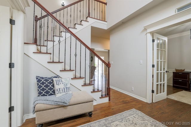 foyer featuring ornamental molding and dark hardwood / wood-style floors