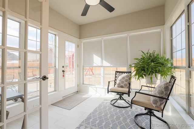 sunroom / solarium featuring ceiling fan