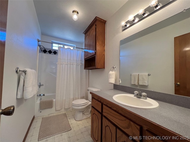 full bathroom with vanity, shower / bath combo with shower curtain, and toilet