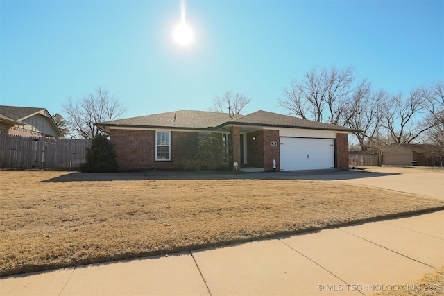 ranch-style house featuring a front lawn and a garage