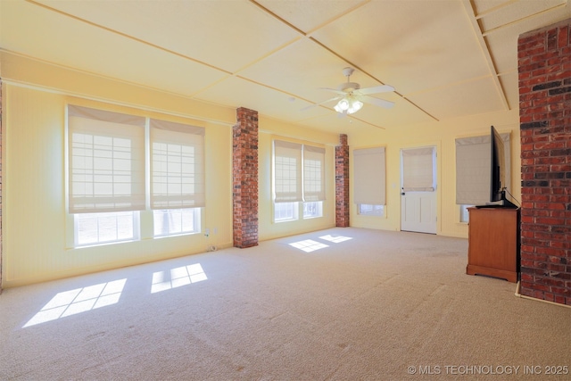 unfurnished living room featuring ceiling fan and light carpet