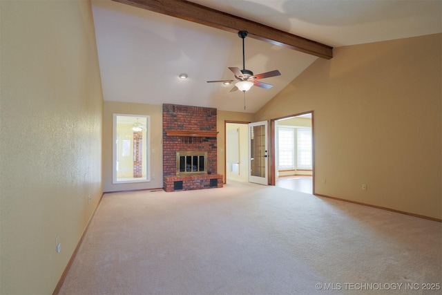 unfurnished living room featuring ceiling fan, a fireplace, high vaulted ceiling, beamed ceiling, and light carpet