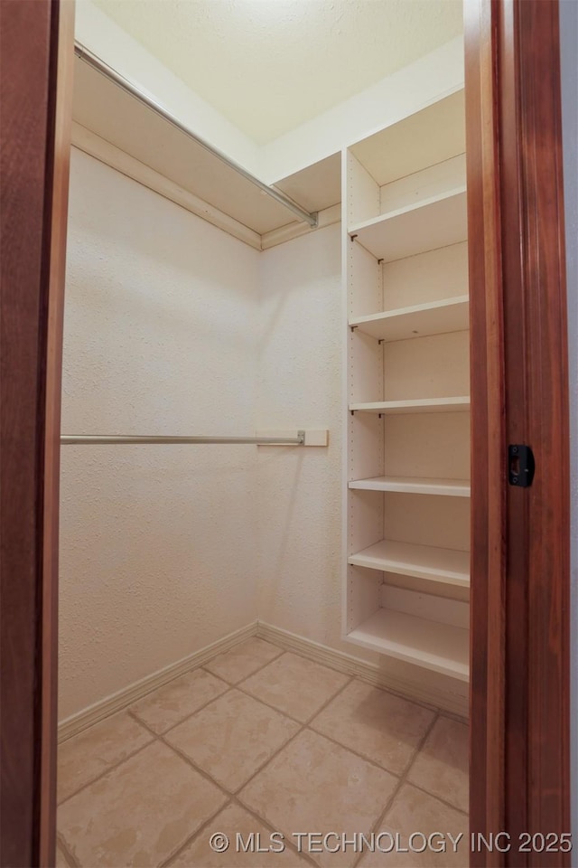 spacious closet featuring tile patterned floors