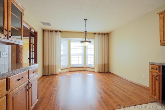 unfurnished dining area with light hardwood / wood-style flooring