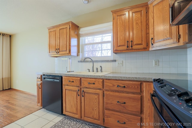 kitchen with black appliances, light tile patterned floors, sink, and tasteful backsplash