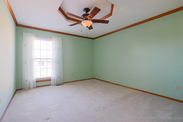 empty room featuring ceiling fan, light colored carpet, and crown molding