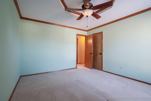 carpeted empty room featuring ceiling fan and ornamental molding