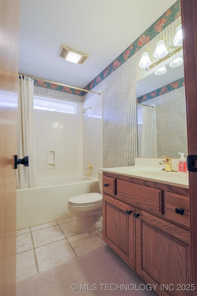 full bathroom featuring toilet, tile patterned floors, vanity, and shower / tub combo with curtain