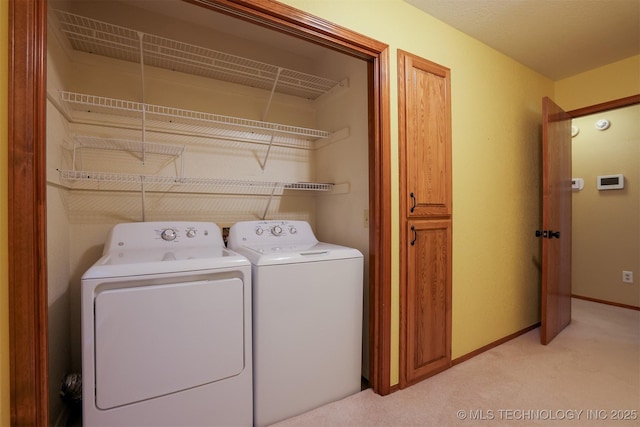 clothes washing area featuring light carpet and washing machine and dryer