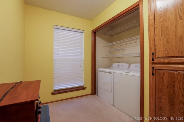 clothes washing area featuring washing machine and dryer and light colored carpet