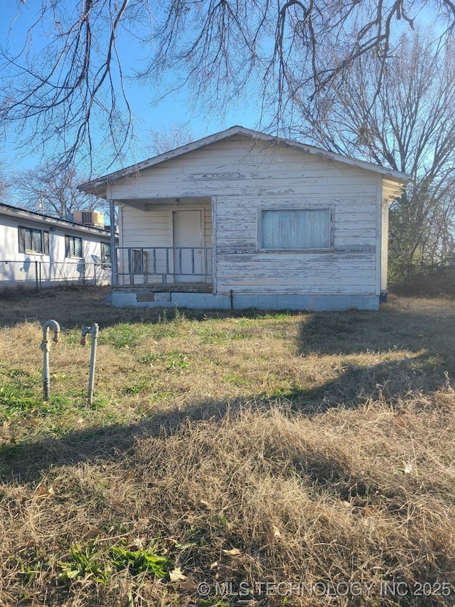 view of front of house with a front yard and a porch