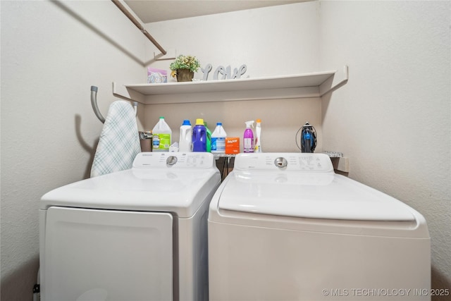 laundry area featuring washing machine and clothes dryer