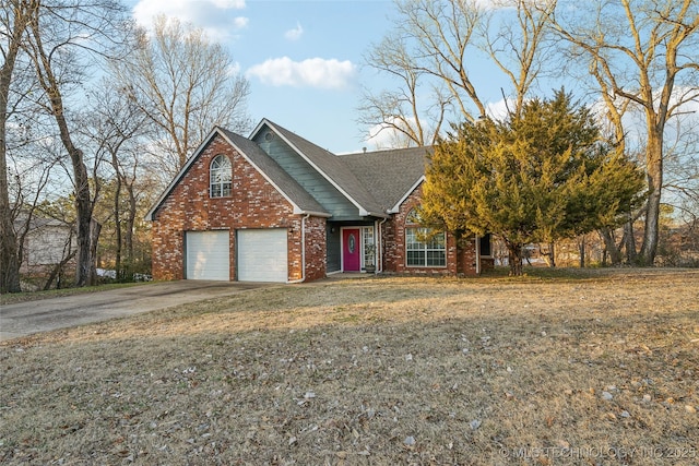 view of front of property with a front yard and a garage