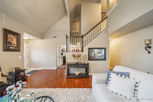 living room featuring hardwood / wood-style floors and high vaulted ceiling