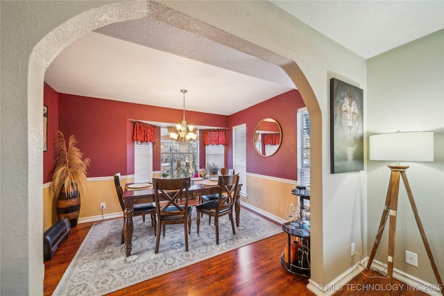 dining space featuring a notable chandelier and dark hardwood / wood-style floors