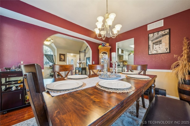 dining area featuring a chandelier and hardwood / wood-style floors