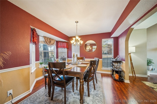 dining space with a chandelier and hardwood / wood-style flooring