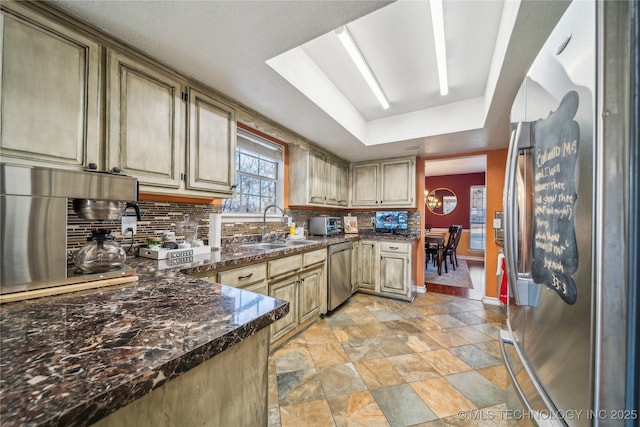 kitchen with sink, backsplash, and appliances with stainless steel finishes