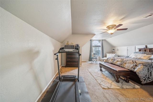 carpeted bedroom with a textured ceiling, ceiling fan, and vaulted ceiling