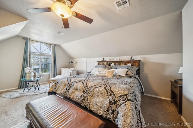 bedroom featuring lofted ceiling, carpet flooring, a textured ceiling, and ceiling fan