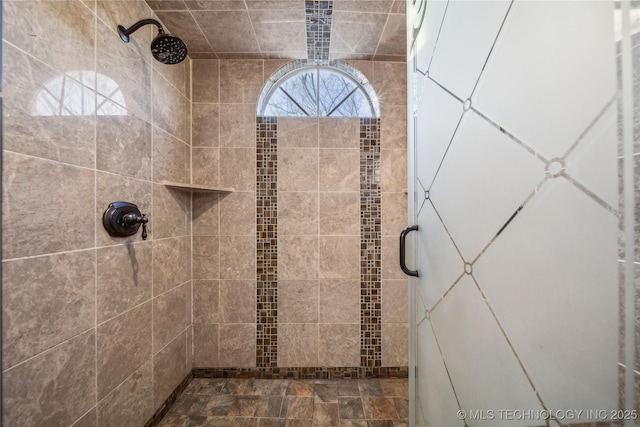 bathroom with a tile shower