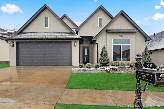 view of front of home featuring a front yard and a garage