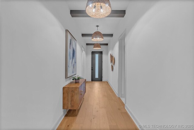 hallway with a chandelier and light wood-type flooring