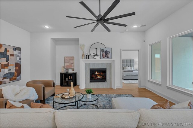 living room with ceiling fan and light hardwood / wood-style floors