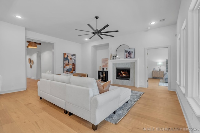 living room with ceiling fan and light wood-type flooring