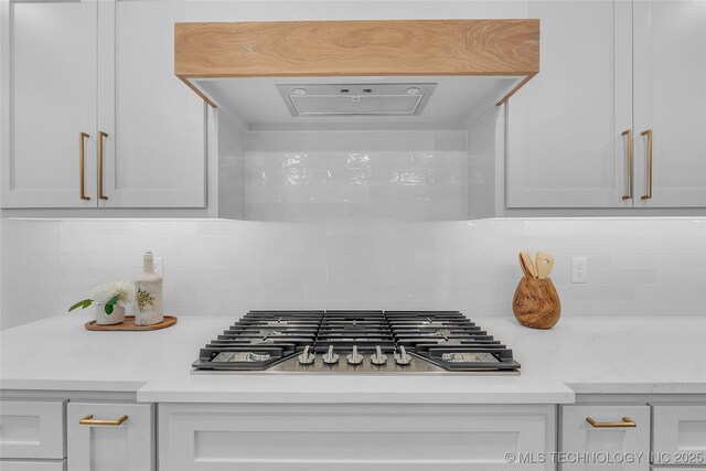 room details with stainless steel gas stovetop and backsplash