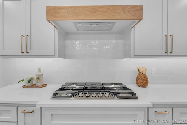 room details featuring backsplash and stainless steel gas stovetop