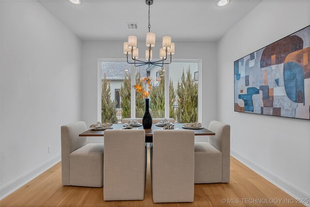 dining room with a chandelier and hardwood / wood-style floors