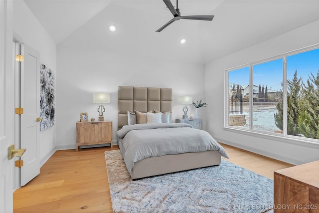 bedroom with vaulted ceiling, ceiling fan, and hardwood / wood-style floors