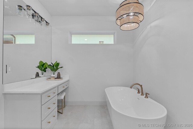 bathroom featuring vanity and a bath