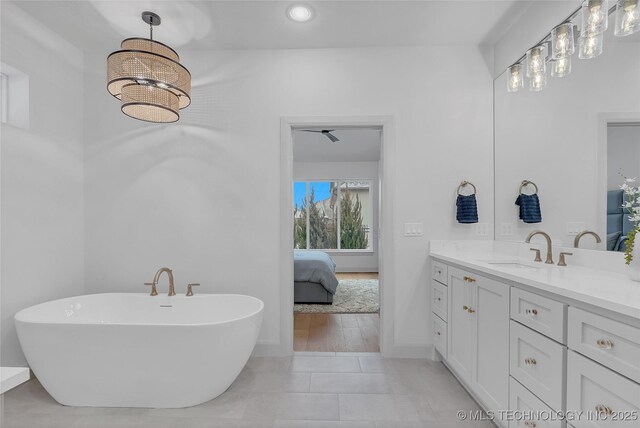 bathroom with vanity, tile patterned floors, and a bathing tub