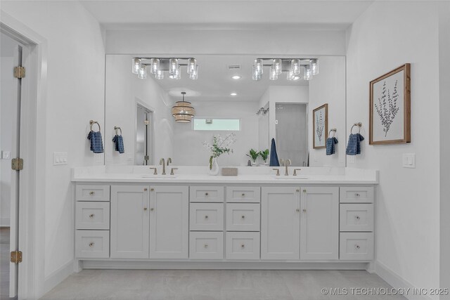 bathroom with tile patterned flooring and vanity